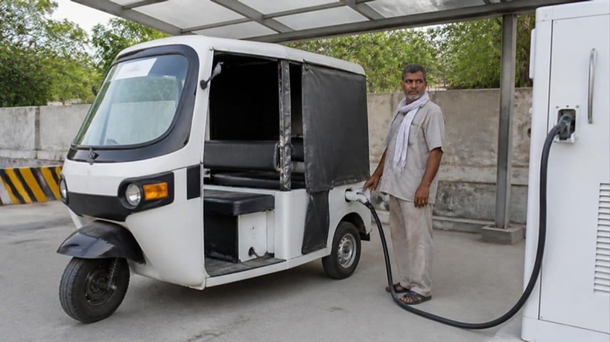 Driver charging an electric auto-rickshaw